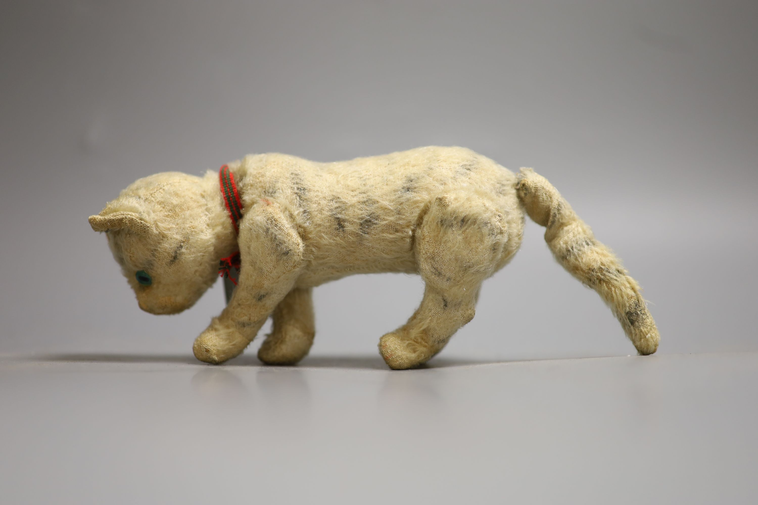 A Steiff miniature Teddy bear, 10cm high together with a cat